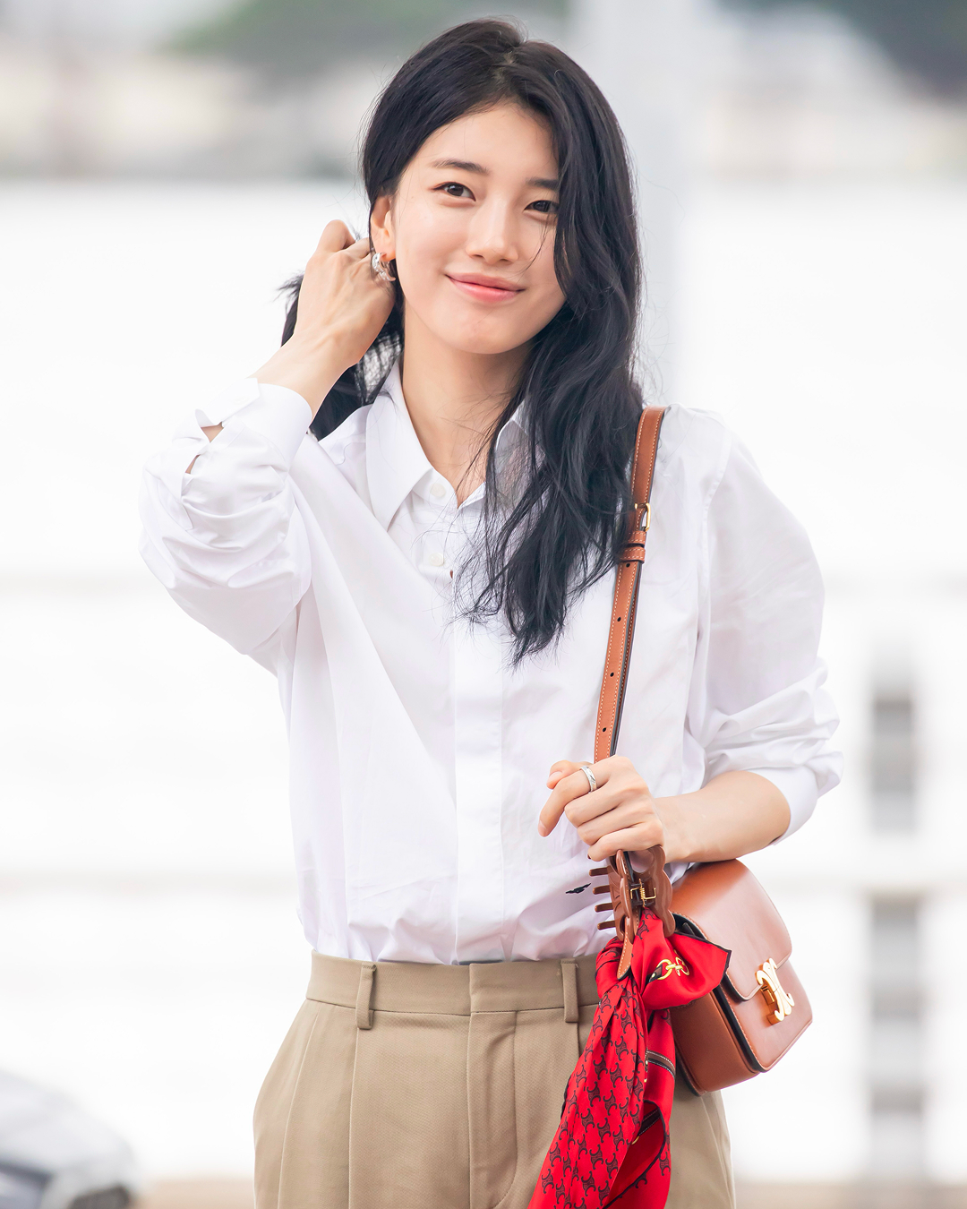 수지의 공항패션 얼굴이 다했자나💖
셔츠와 슬랙스에 로고 아이템 포인트까지, 인간 셀린느 완성

가방부터 헤어 클로까지, 수지의 공항패션은 빈틈없이 완성됐습니다.

1. 클래식 트리옹프 백 내추럴 카프스킨, 600만 원대
수지가 착용한 백은 셀린의 트리옹프 백으로, 골드 메탈 트리옹프 로고가 특징입니다. 화이트 셔츠와 베이지 팬츠에 고급스러운 포인트를 더했습니다.

2. 반다나 헤리티지 실크 트윌, 39만 원대
트리옹프 백 손잡이에 레드컬러의 실크 스카프를 묶었습니다. 트윌리 스타일을 연상시키는 스타일링 팁으로, 톤온톤 룩에 생기를 불어 넣었습니다. 

3. 루즈 코튼 포플린 셔츠, 105만 원대
코튼 포플린 소재에 트리옹프 자수를 더한 셔츠는 베이지 컬러 트라우저와 매치했습니다. 단정한 셔츠지만 오버사이즈 실루엣 덕분에 클래식하면서도 여유로운 무드를 자아냅니다. 

4. 라지 헤어 클로 아세테이트, 66만 원대
가방 끈에 집어 연출한 브라운 컬러의 셀린 헤어집게는 이 룩의 결정적 디테일. 셀린느 트리옹프 로고 쉐입의 헤어 클로를 액세서리처럼 활용해 감각적인 연출을 완성했습니다. 이미지6