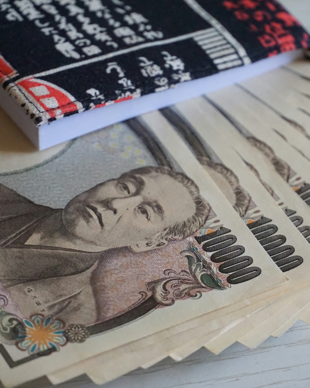 가치 하락에🇯🇵엔화 예금 역대 최고
계산기 두드려 봤습니다 🧮
100만 원을 엔화로 바꾸면 지난달보다 1만 엔 넘게 더 받습니다. 원엔 환율이 100엔당 860원 선까지 내려왔습니다. 28일 오전 866.35원, 2024년 7월 11일(852.72원) 이후 2년 1개월 만에 가장 낮은 수준입니다.
속도가 빠릅니다. 지난달 1일 955.63원이었으니 두 달이 채 안 돼 89원이 빠졌어요. 5대 은행 엔화예금 잔액도 25일 기준 1조3,456억 엔으로 역대 최고를 갈아치웠습니다.
다만 계산이 하나 더 붙습니다. 7월 1일부터 일본 출국세가 1,000엔에서 3,000엔으로 올랐습니다. 4인 가족이면 1만 2,000엔, 우리 돈 10만 원가량입니다. 숙박세와 교통패스도 함께 올랐습니다.
그래도 갑니다. 올해 상반기 일본을 찾은 한국인은 567만 5,100명, 1년 전보다 18.6% 늘었습니다. 전체 방일 외국인 중 1위, 넷 중 하나가 한국인이었습니다. 이미지1
