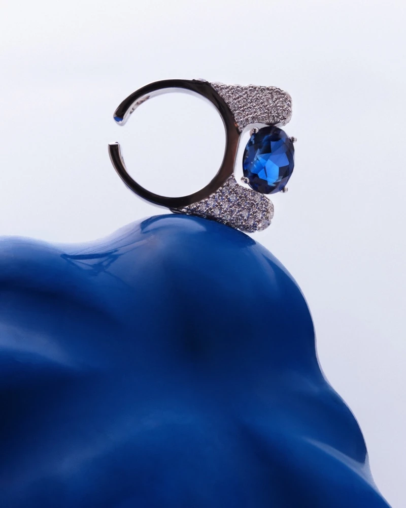 도버스트릿 블루 사파이어💙노미스
빙글빙글 돌리는 인싸템 고급미💍🩵 노미스 ‘아인트호벤‘
손끝으로 빙글 돌려 보이는 이 반지, 노미스의 '아인트호벤'이에요. 블루 사파이어 양옆을 다이아몬드로 감싼 피스로, 반지로 끼다가 이어커프나 펜던트로도 바꿔 찰 수 있죠.
노미스는 2020년 키이우에서 변호사 출신 디자이너 알료나 키퍼먼이 세운 브랜드입니다. 반지는 이어커프로, 이어핀은 펜던트로, 팔찌는 초커로 바뀌는 주얼리를 성별 구분 없이 만들어요.
18K 골드에 랩그로운 스톤을 쓰고, 이어핀은 1천 달러대부터 시작합니다. 도버 스트리트 마켓 런던·뉴욕·LA 세 곳에 모두 들어가 있죠.
• 노미스 아인트호벤 이미지2