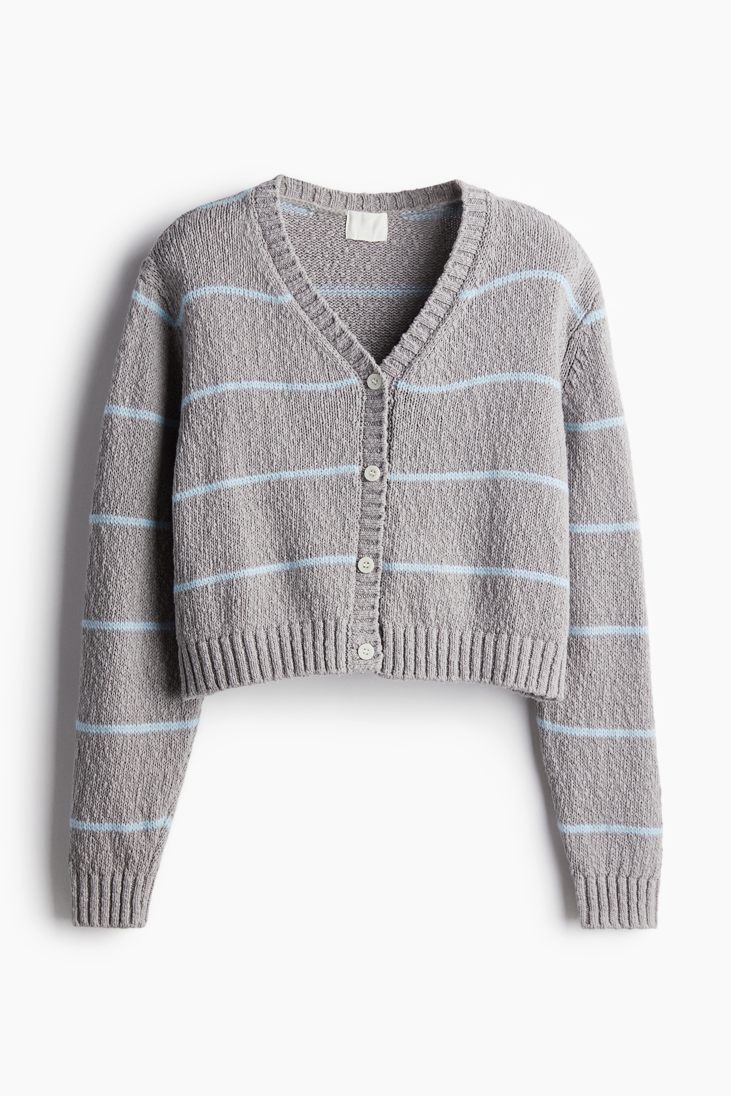 부드러운 슬러브 니트 소재의 V넥 가디건. 앞면 버튼 클로저. 드롭 숄더. 리브드 옷단. 이미지