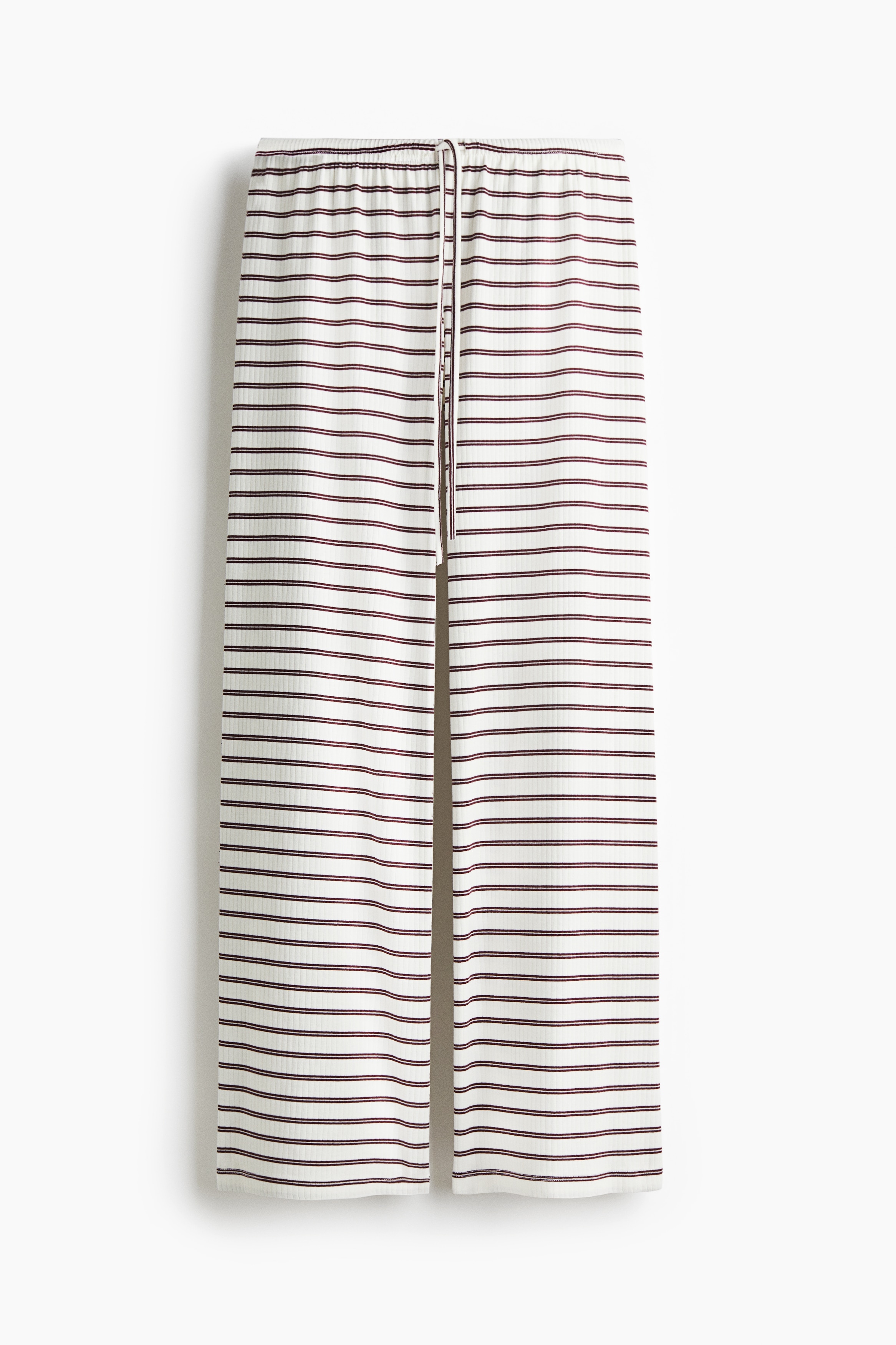 코튼이 혼방된 리브드 저지 소재의 와이드 팬츠. 릴랙스핏. 로라이즈. 가는 드로스트링이 있는 신축성 허릿단. 이미지