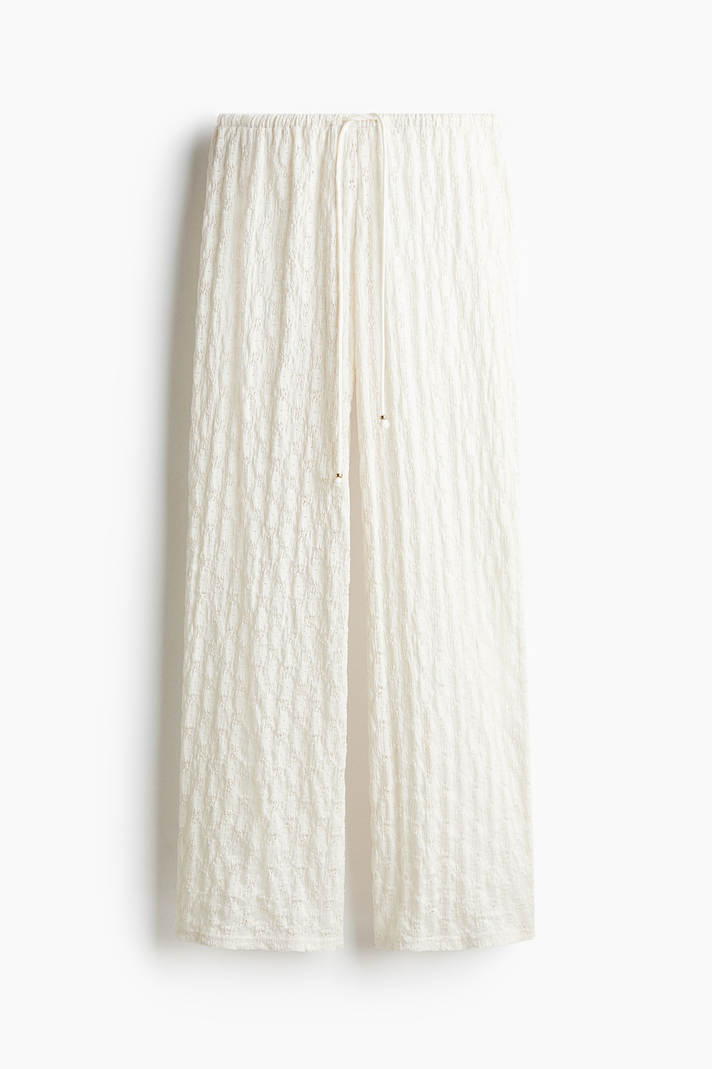 부드러운 레이스 느낌 저지 소재의 루즈핏 팬츠. 로라이즈. 드로스트링이 있는 신축성 허릿단. 수퍼 롱 레그. 이미지