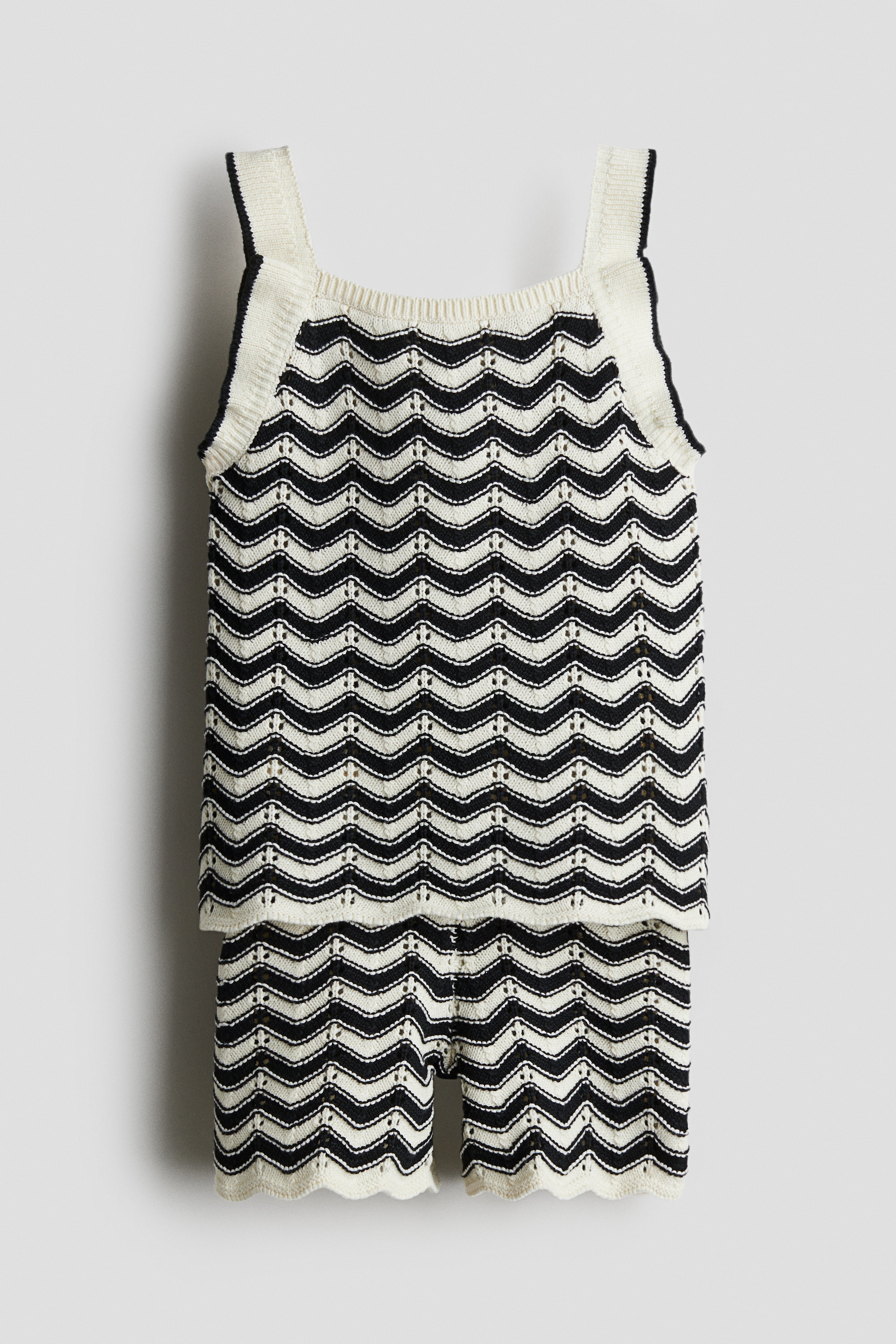 H & M Adorables. 고급 코튼을 사용한 포인텔 파인니트 소재의 스트랩 탑과 반바지 세트. 스캘럽트 라인의 트리밍 디테일. 탑 - 스퀘어넥. 반바지 - 밴딩으로 허리 사이즈 조절. H & M Adorables 컬렉션은 시대를 초월한 매력을 지닌 매우 편안하고 고급스러운 제품들로 엄선된 컬렉션입니다. 이미지