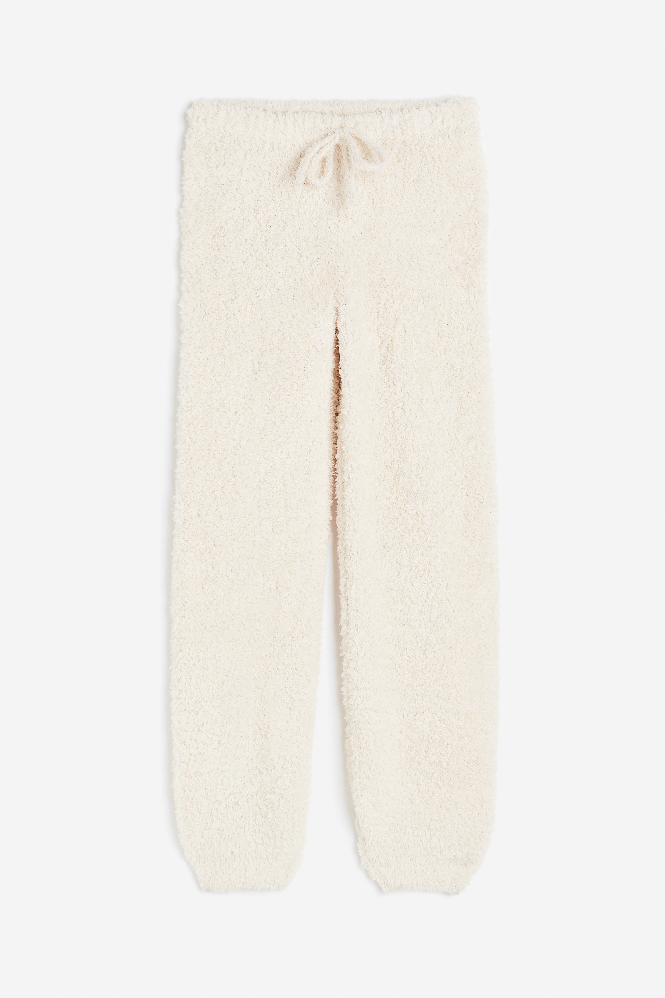 폭신한 니트 소재의 캐주얼 스타일 조거 팬츠. 릴랙스핏. 드로스트링이 있는 신축성 허릿단. 테이퍼드 레그. 커프 아랫단. 이미지