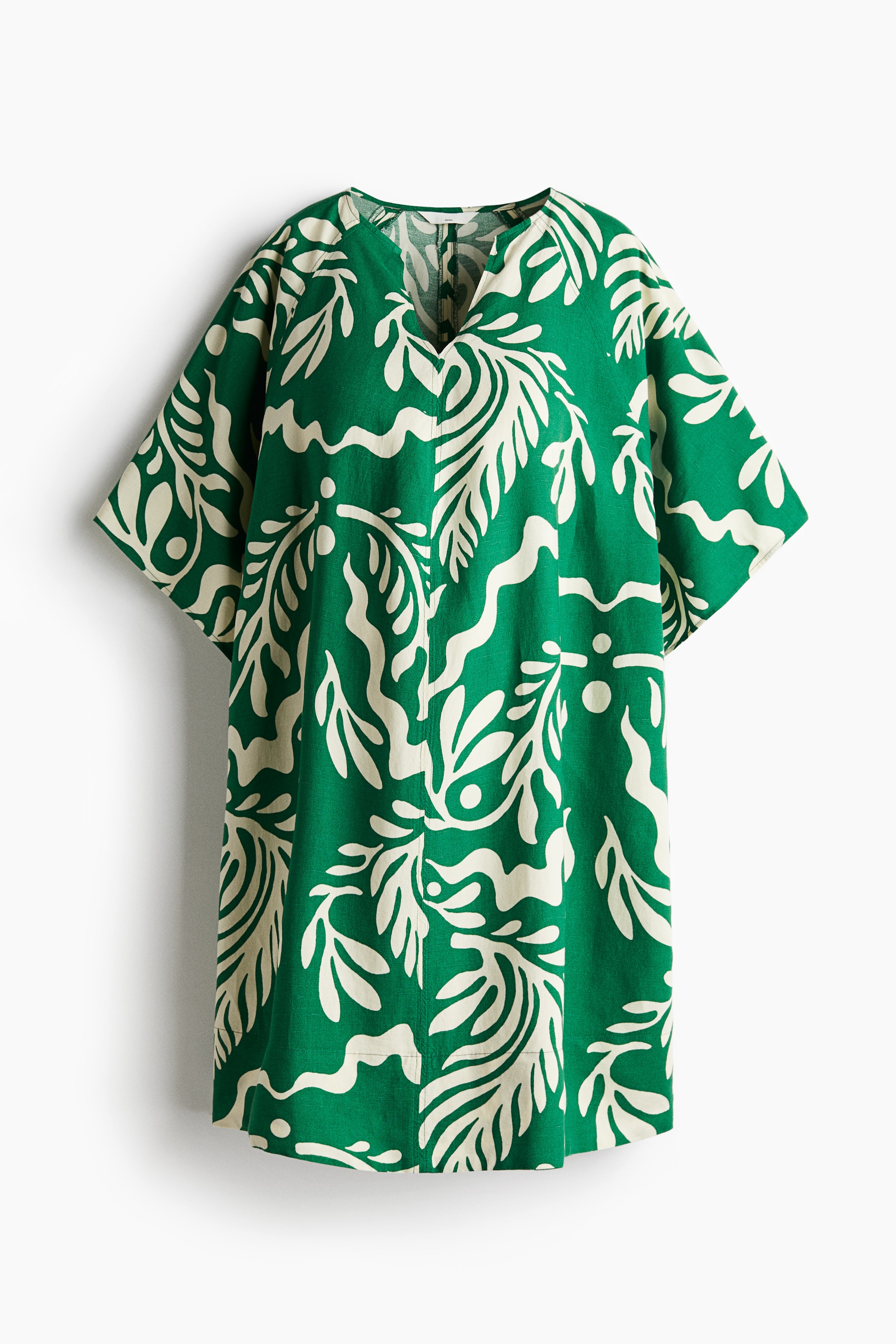 리넨과 비스코스가 혼방된 가벼운 우븐 소재의 니렝스 튜닉 드레스. 루즈핏. V넥. 래글런 스타일의 5부 소매. 임부와 수유부 모두 착용할 수 있음. 안감 생략. 이미지