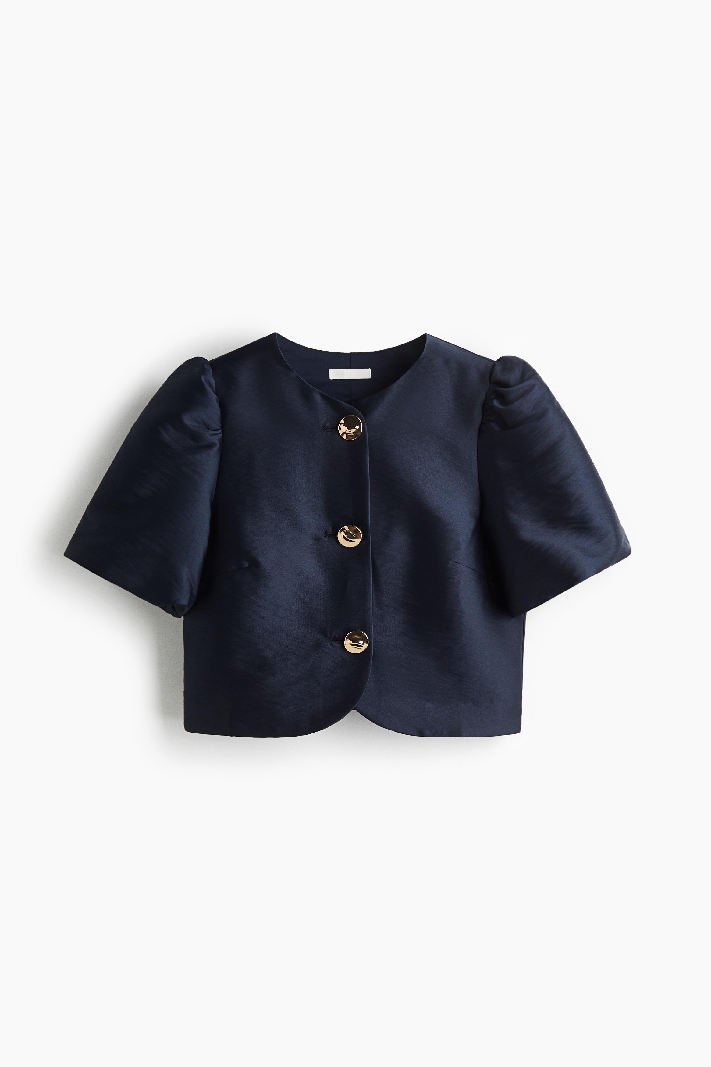 Short blouse in woven fabric with a round neckline and short puff sleeves. Gently hammered metal buttons down the front. 이미지1