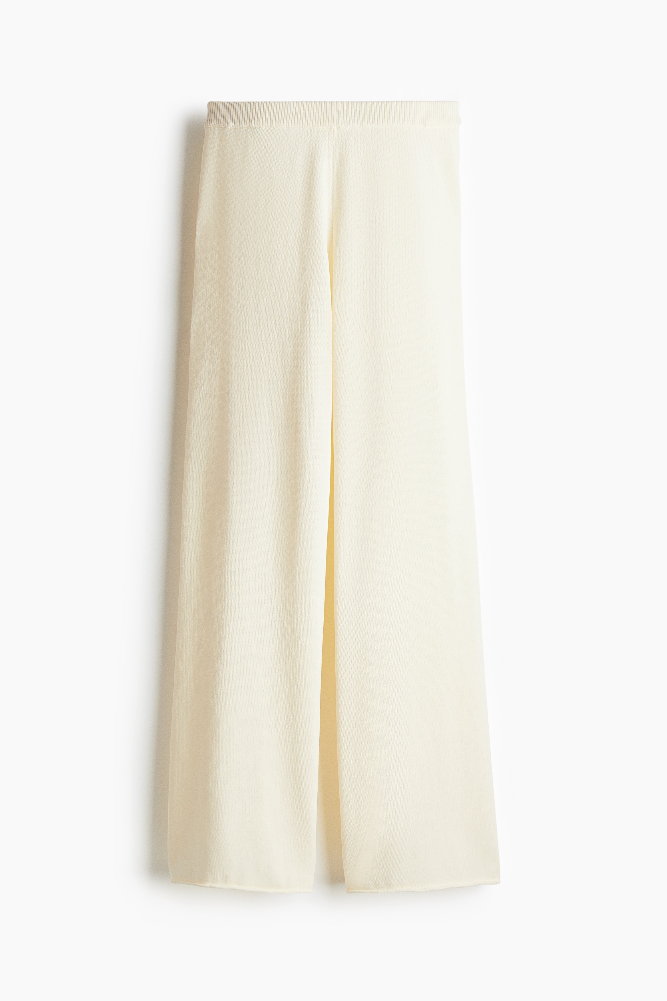 부드러운 니트 소재의 팬츠. 리브드 마감된 신축성 허릿단. 스트레이트 레그. 말려들어간 아랫단. 이미지