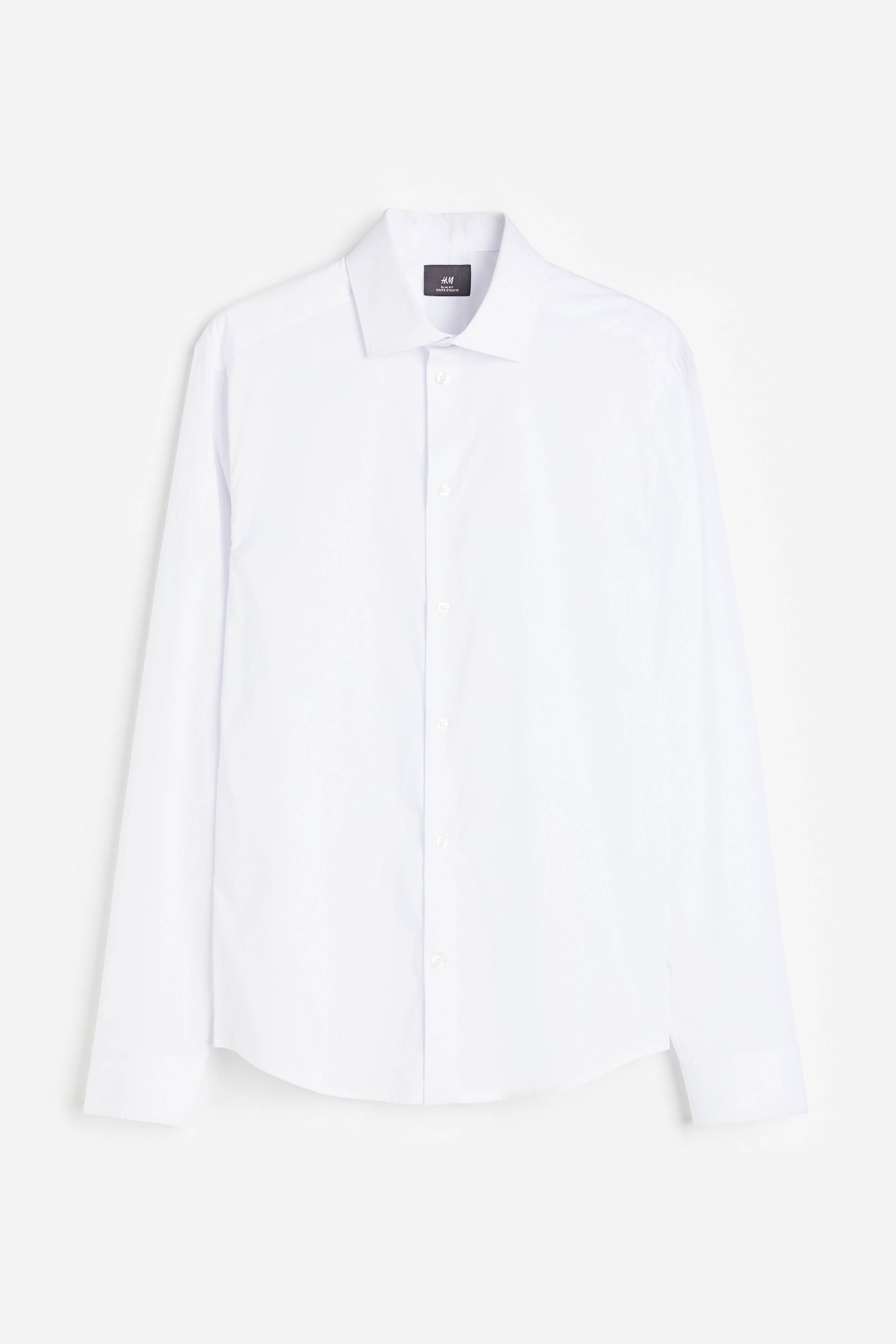 코튼이 혼방된 스트레치 우븐 소재의 셔츠. 커터웨이 칼라. 버튼단이 있는 클래식 프런트 스타일. 뒷면 요크 디테일. 플래킷과 링크 버튼이 있는 긴소매. 버튼으로 핏 조절 가능한 소맷단. 세미 라운드 헴라인. 바디 라인을 감싸며 피트되는 슬림핏 실루엣. 이미지