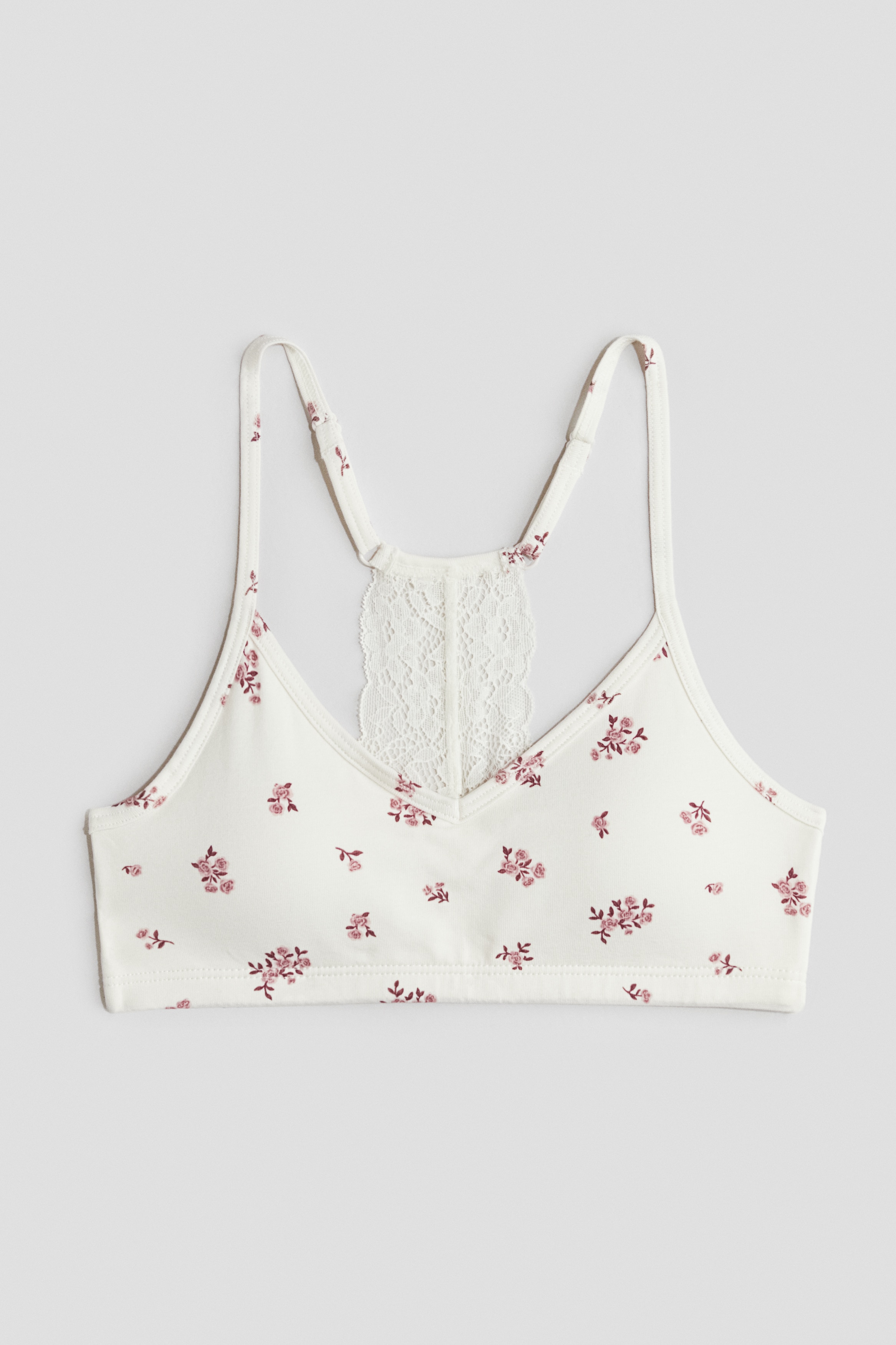 부드러운 코튼 저지 소재의 크롭트 탑. V넥. 뒷면 레이스 디테일. 길이 조절 가능한 가는 어깨 스트랩. 탈부착식 캡 내장. 신축성 아랫단. 안감 부착. 이미지