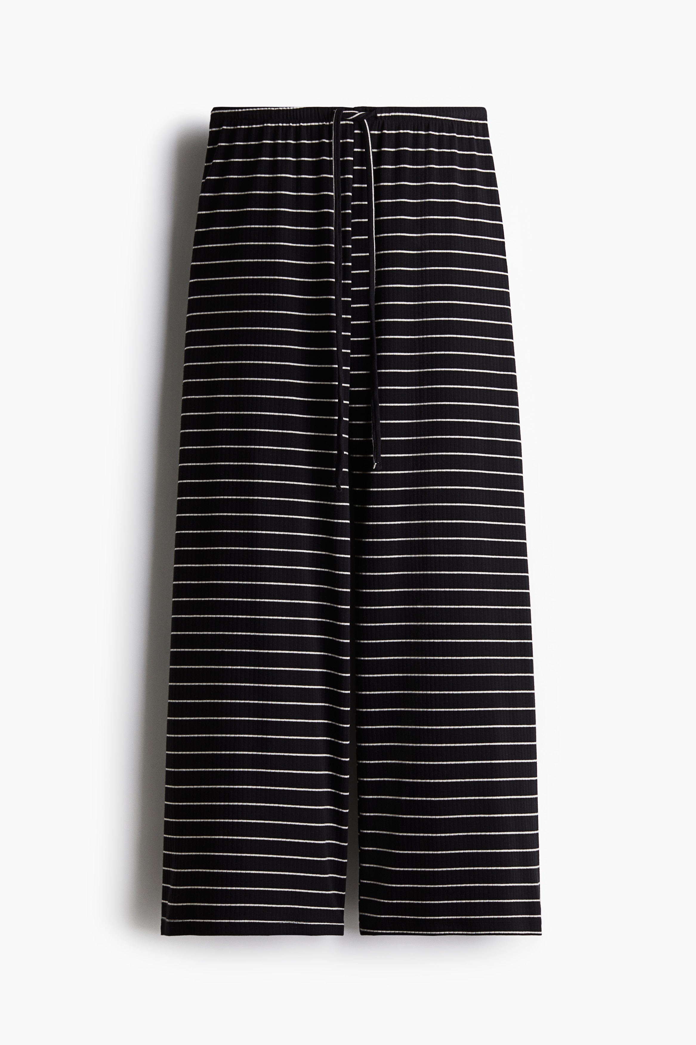 코튼이 혼방된 리브드 저지 소재의 와이드 팬츠. 릴랙스핏. 로라이즈. 가는 드로스트링이 있는 신축성 허릿단. 이미지