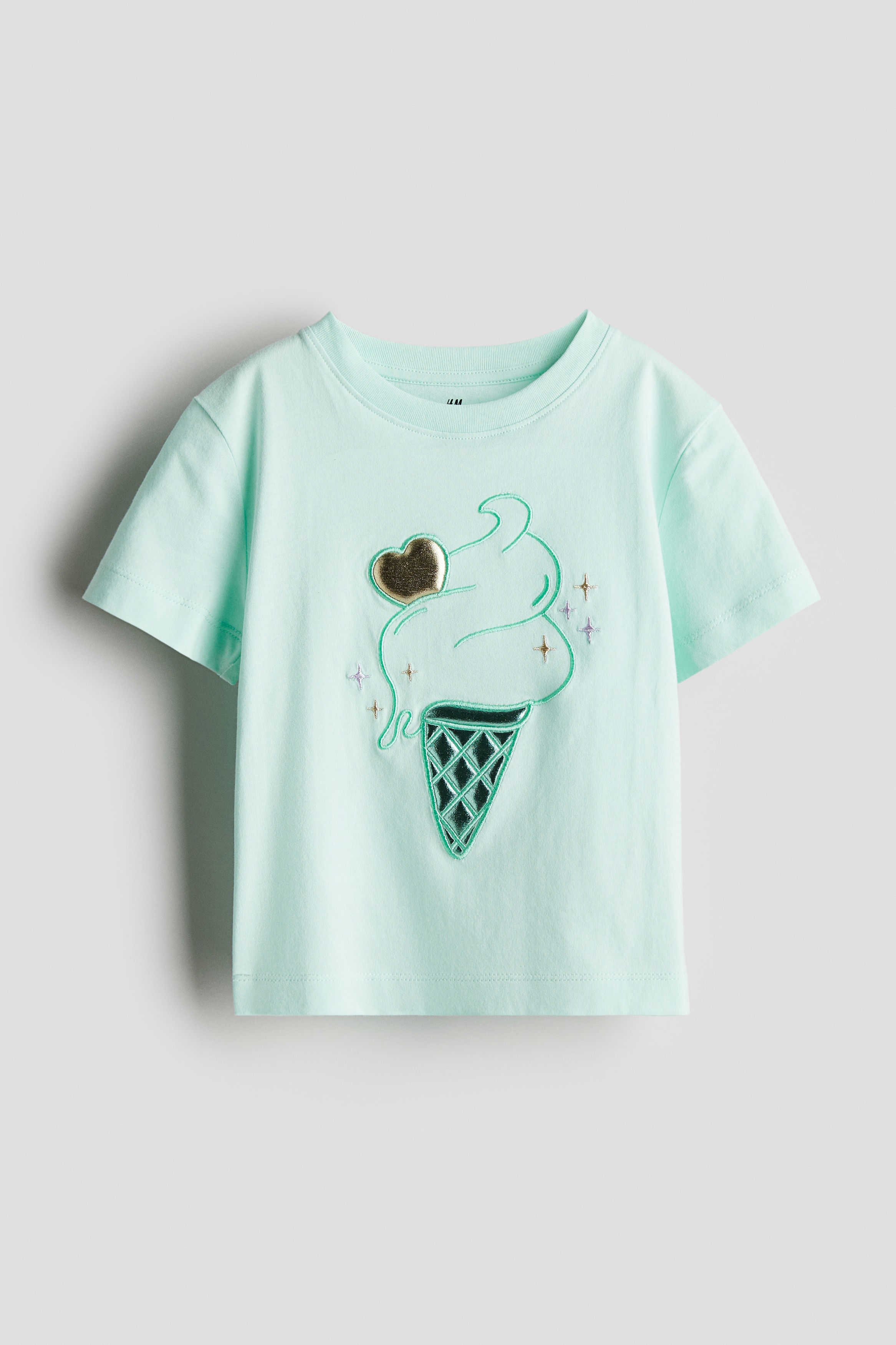 앞면에 장식이 있는 코튼 저지 소재의 티셔츠. 리브드 마감된 라운드 네크라인. 드롭 숄더. 반소매. 이미지