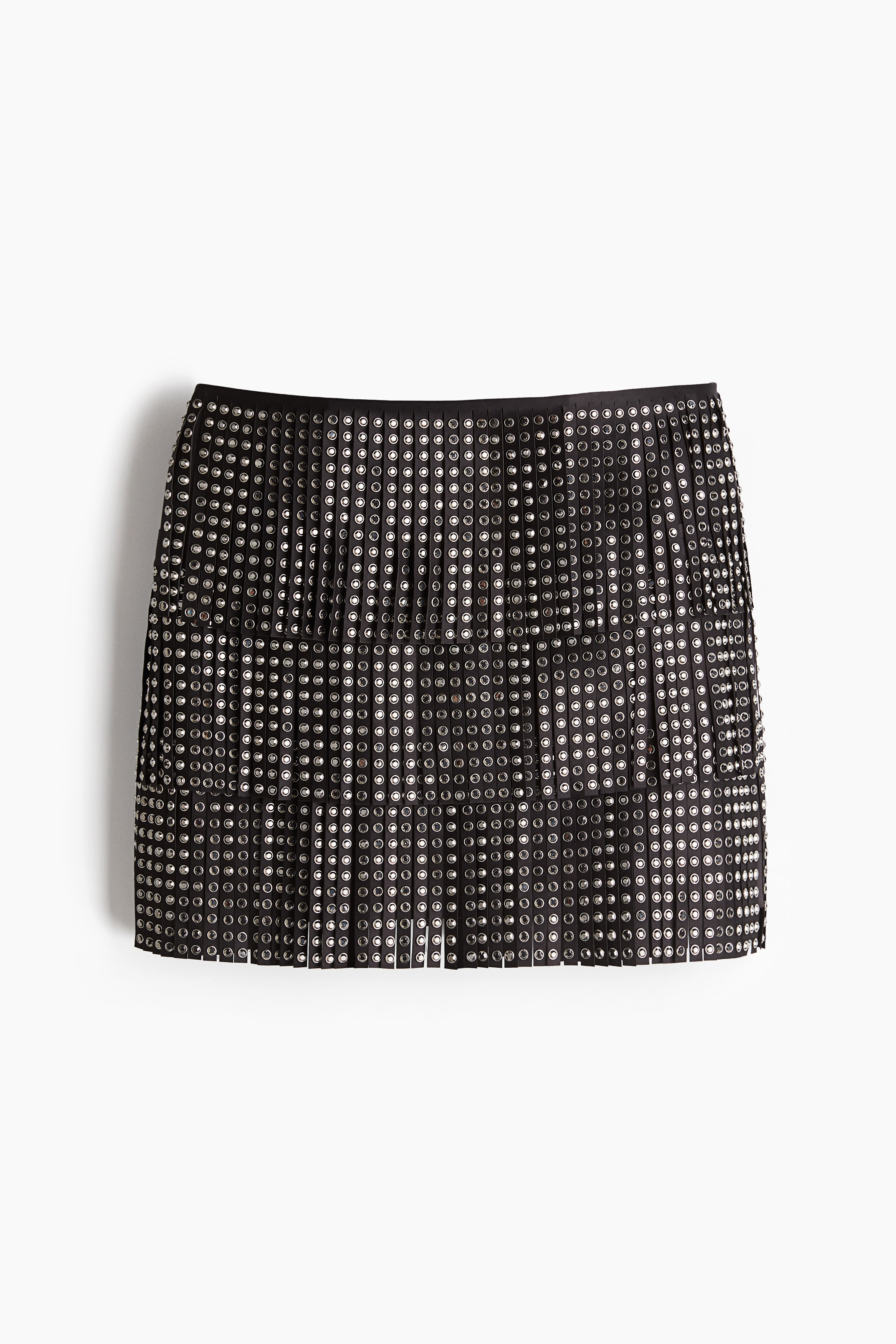 Short, fitted skirt in woven fabric with layers of fringes that are decorated with sparkling rhinestone studs. Shaping darts and a concealed zip and hook-and-eye fastener at the back. 이미지