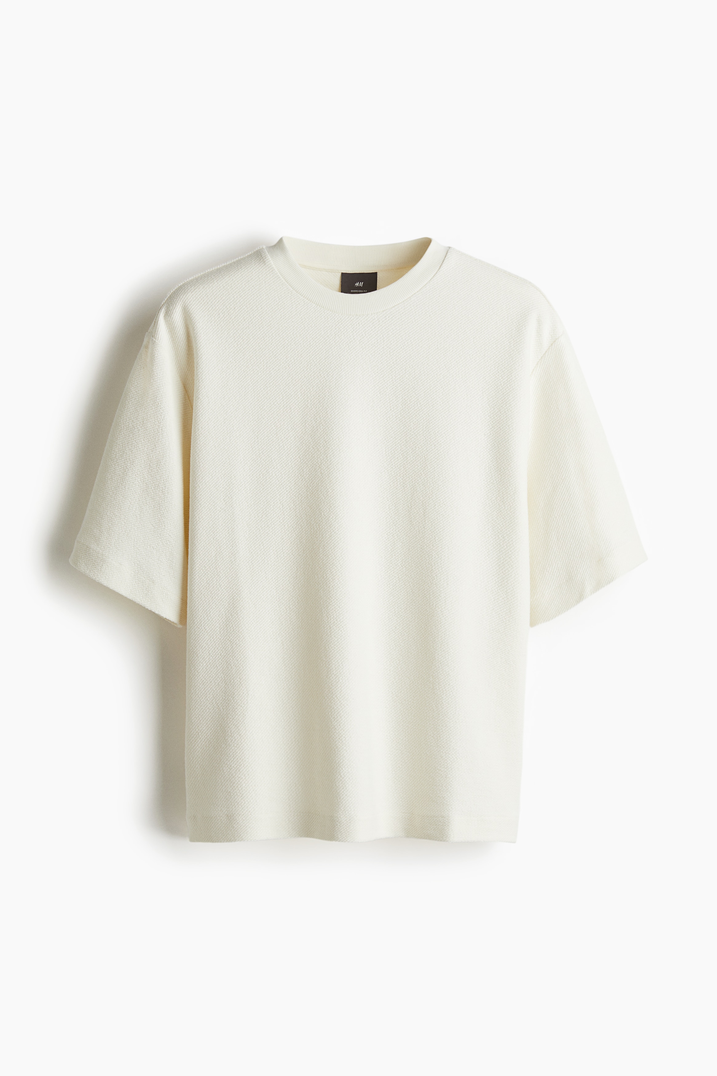 톡톡한 코튼 스웨트셔츠 소재의 박시한 티셔츠. 리브드 라운드넥. 드롭 숄더. 스트레이트 헴라인. 넉넉하고 매우 루즈한 오버사이즈핏. 이미지