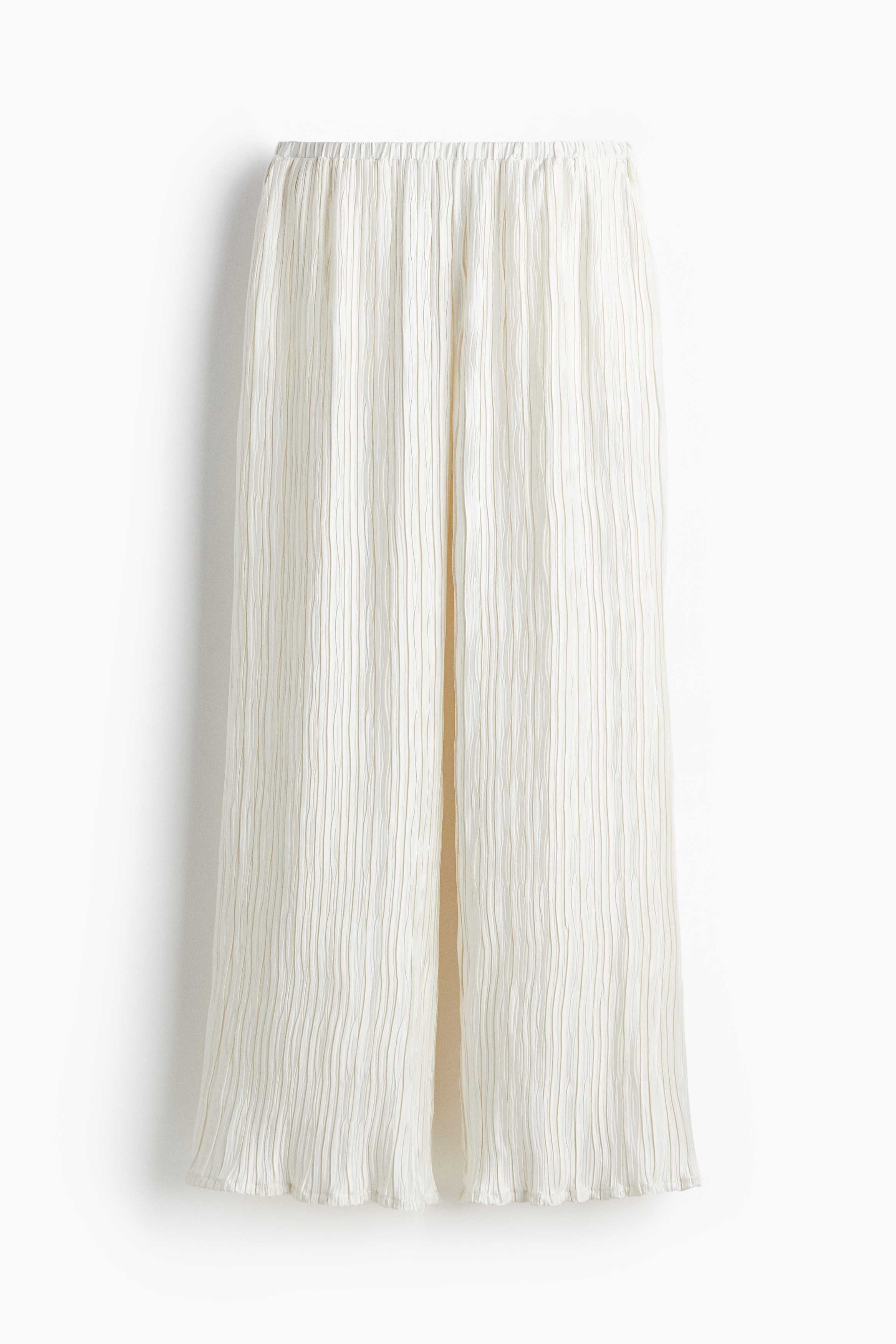 크링클 소재의 팬츠. 신축성 허릿단. 옆면 포켓. 와이드 레그. 아랫단이 오버로크처리됨. 이미지