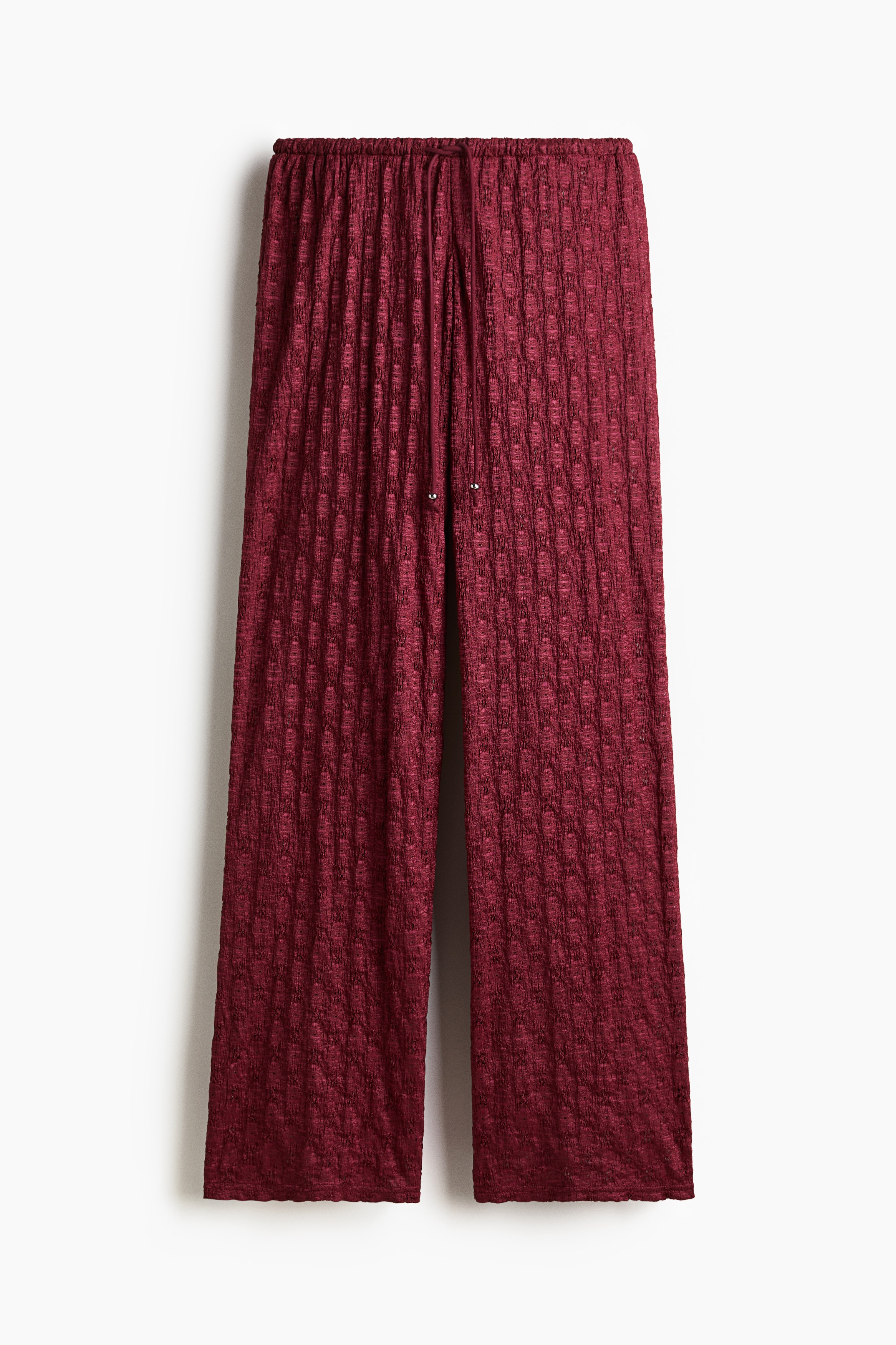 부드러운 레이스 느낌 저지 소재의 루즈핏 팬츠. 로라이즈. 드로스트링이 있는 신축성 허릿단. 수퍼 롱 레그. 이미지