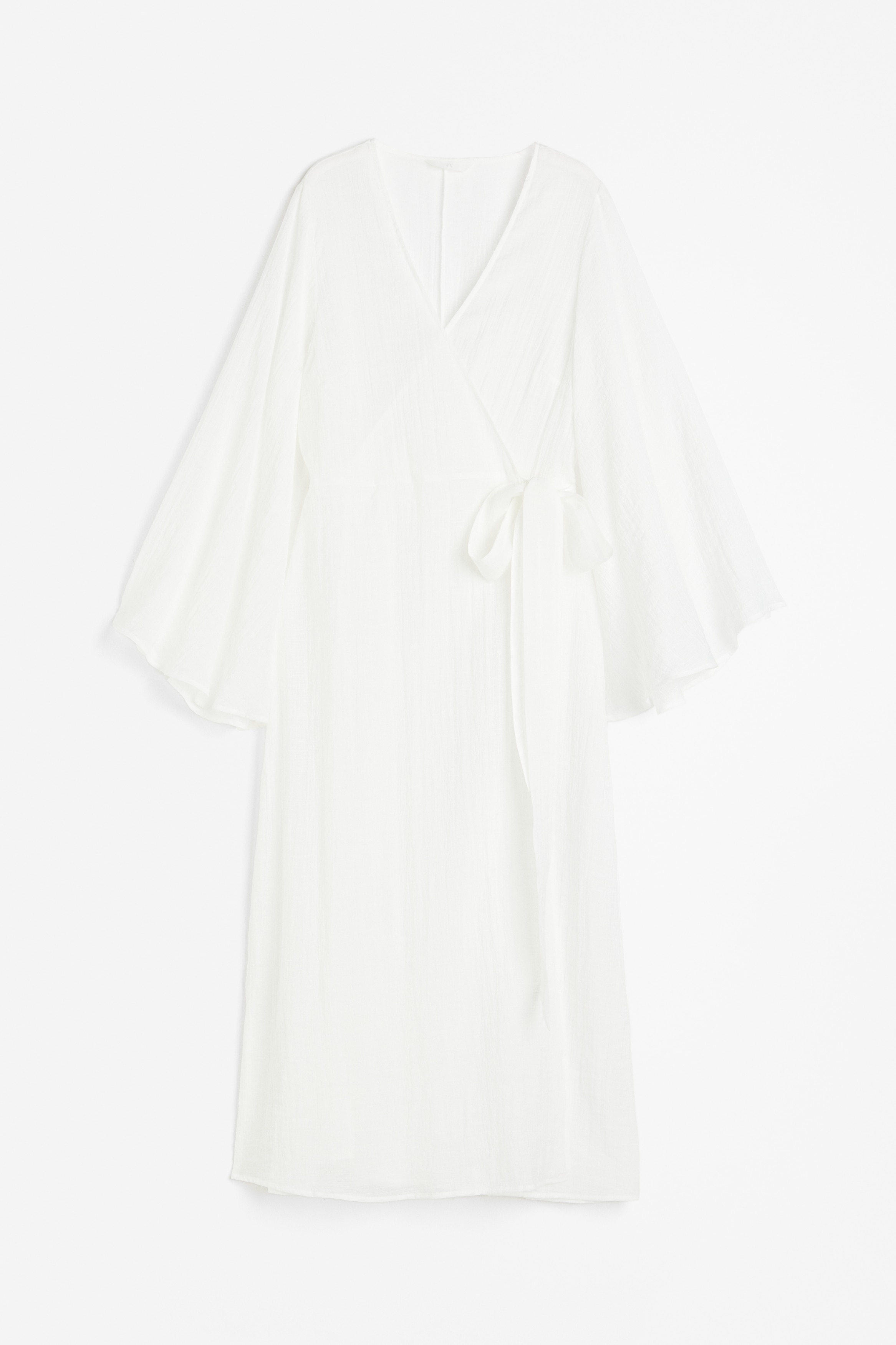 크레이프 소재의 맥시 원피스. 끈 벨트로 여미는 랩스타일. 플레어 라인의 긴소매. 안감 생략. 이미지