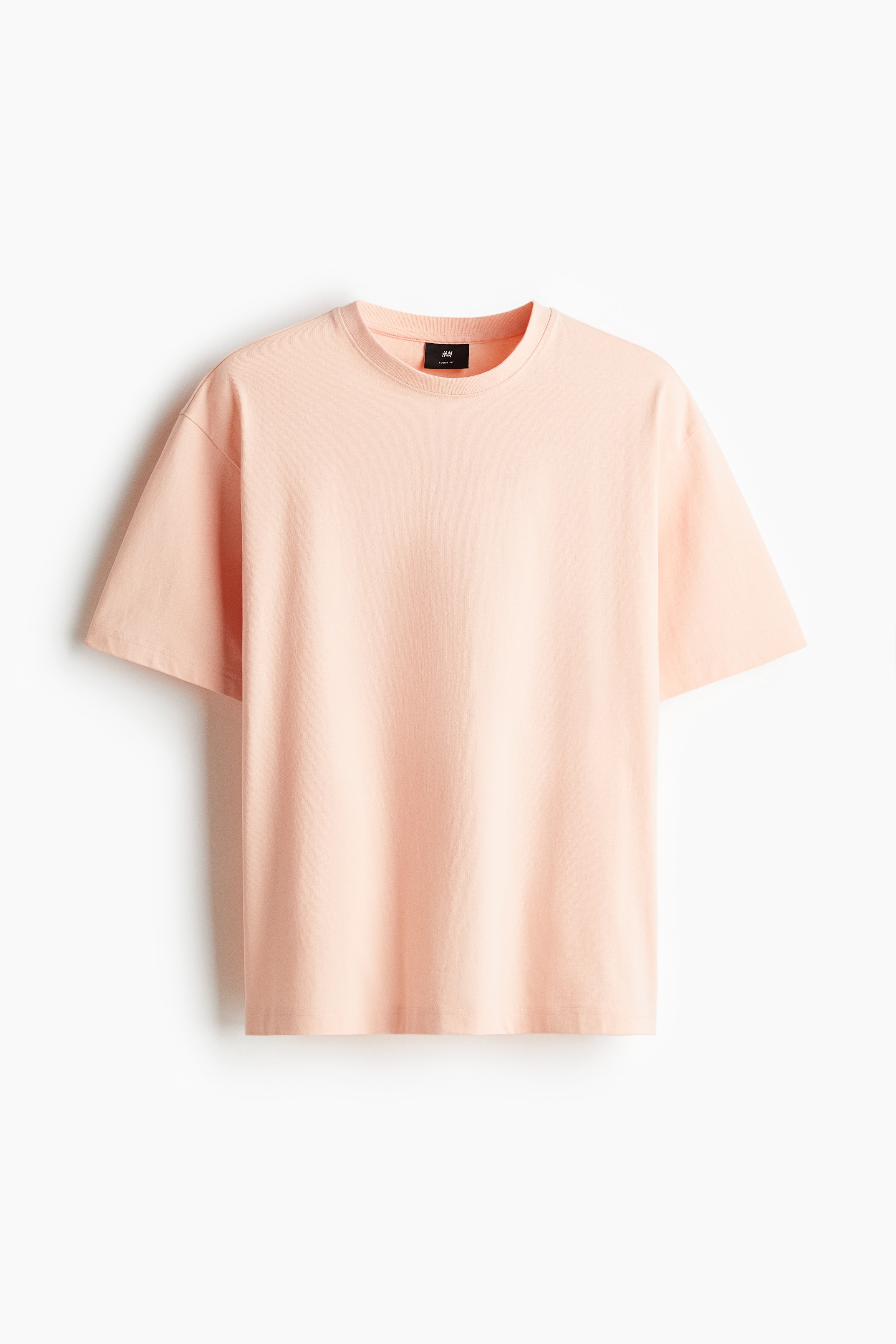 톡톡한 코튼 저지 소재의 티셔츠. 리브드 마감 라운드넥. 드롭 숄더. 스트레이트 헴라인. 넉넉하지만 오버사이즈보다는 약간 피트되는 루즈핏 실루엣. 이미지