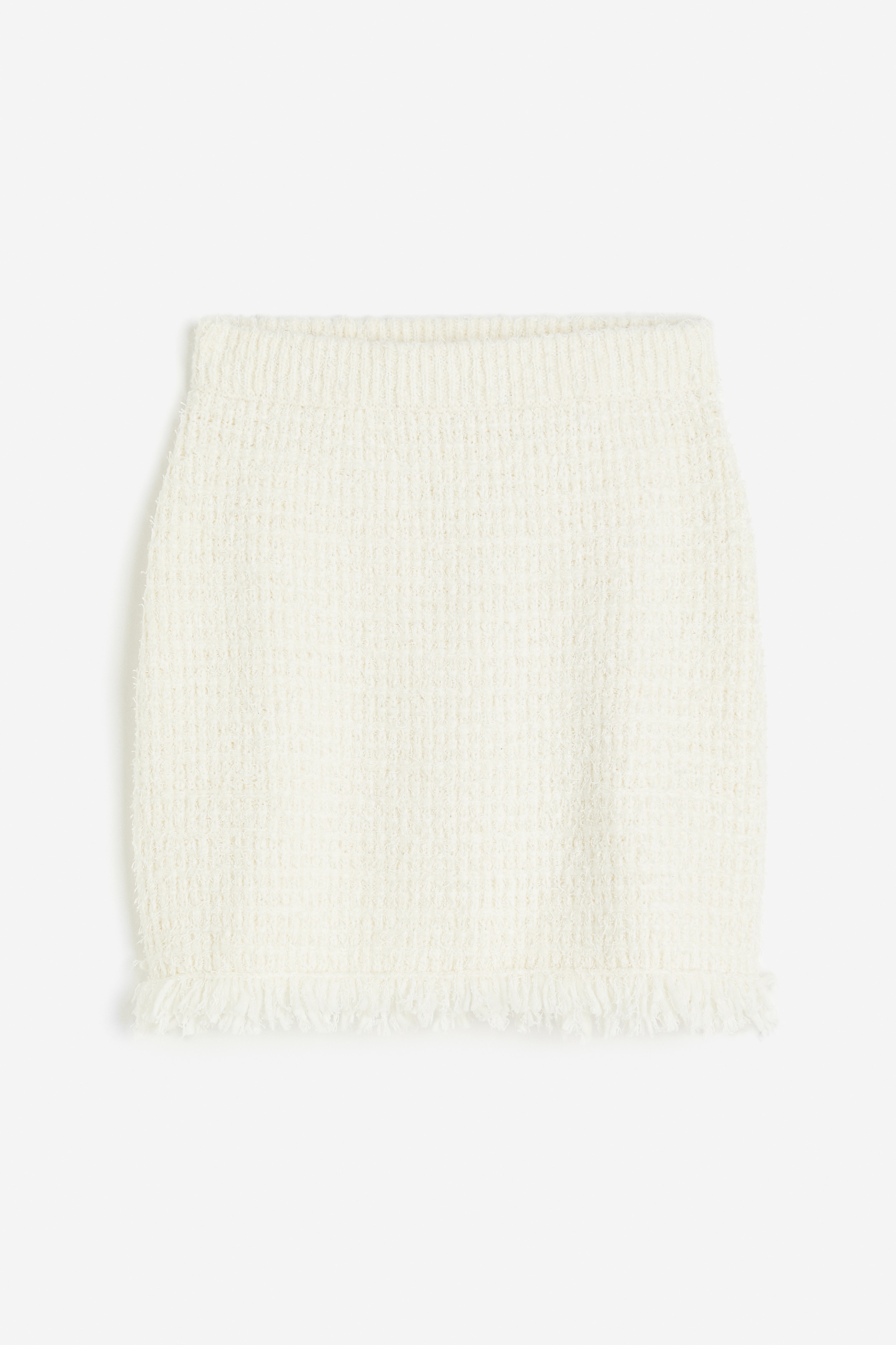 텍스처 니트 소재의 미니 스커트. 신축성 허릿단. 프린지로 마감된 아랫단. 이미지