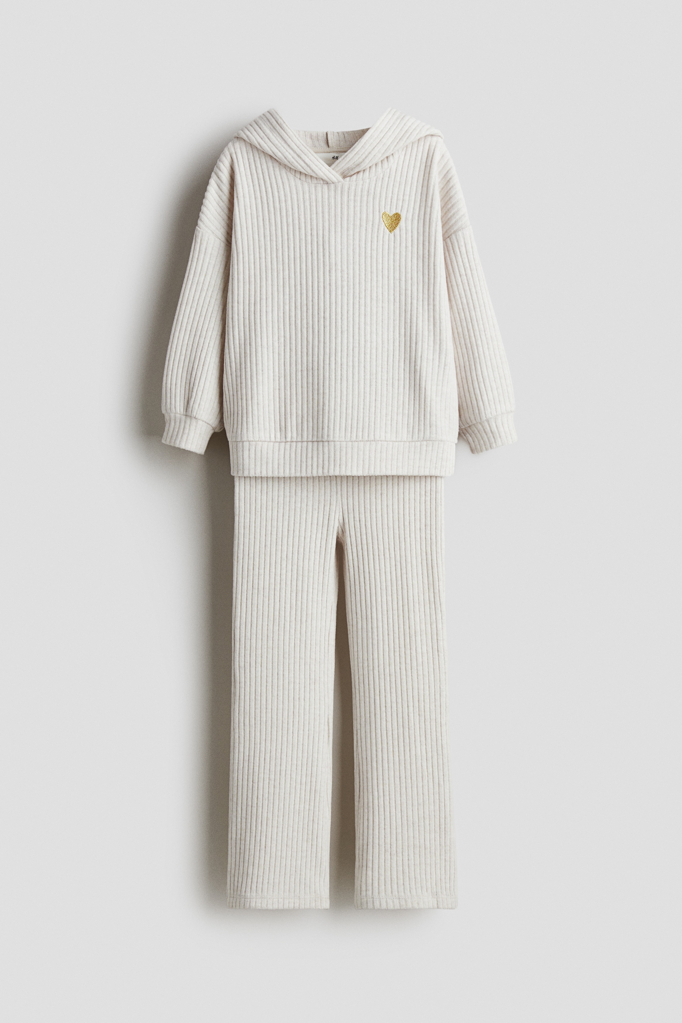 가볍게 기모처리된 비스코스 혼방 리브니트 소재의 상하의 세트. 상의 - 후드 앞면이 랩스타일로 마감된 후드티. 드롭 숄더. 소맷단과 아랫단 트리밍. 하의 - 허릿단에 밴딩이 내장된 세미 플레어 레깅스. 이미지