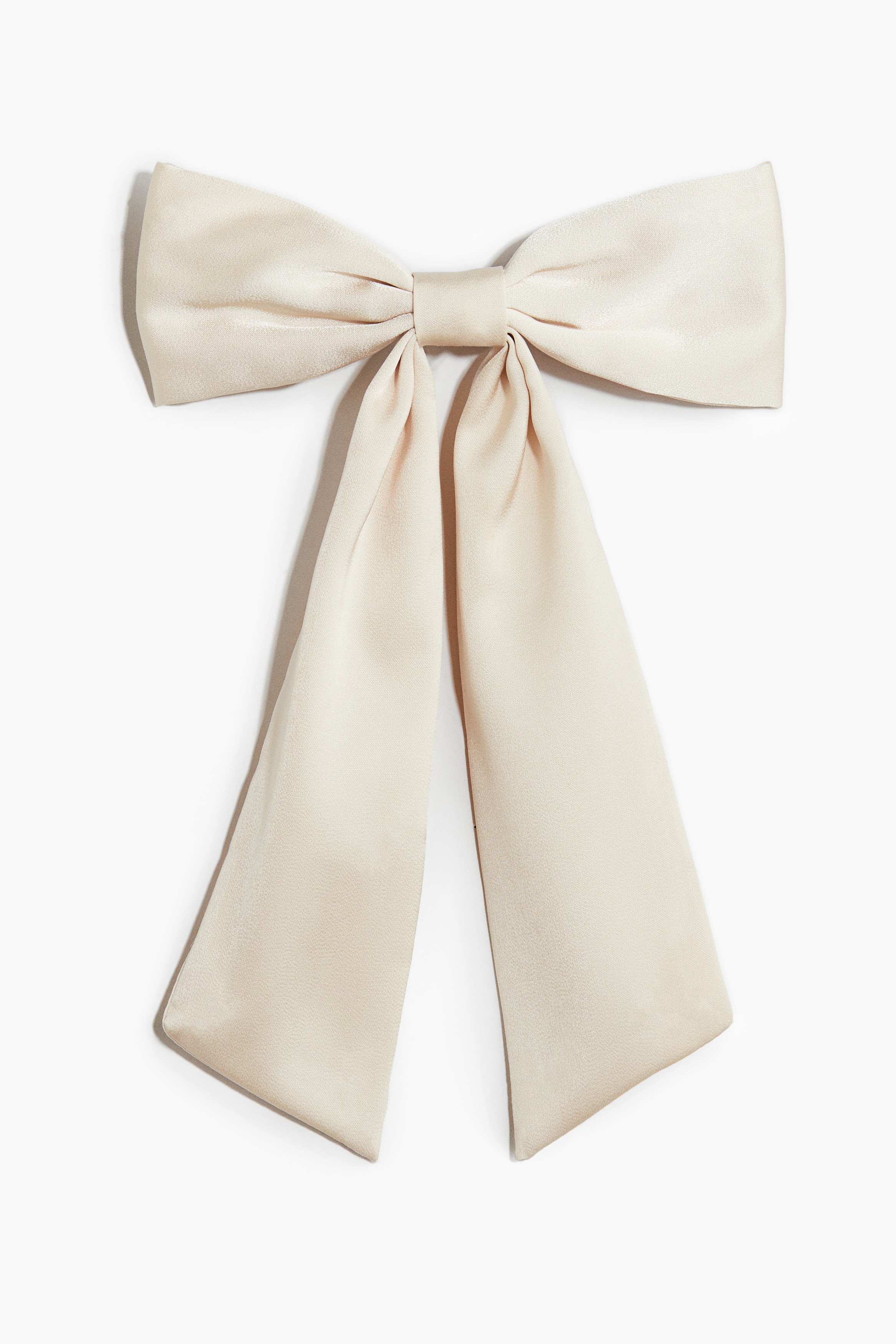 부드러운 패브릭 소재의 볼드한 리본으로 장식된 금속 헤어 클립. 이미지