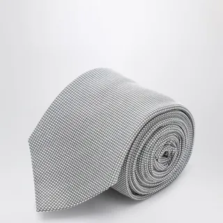 살바토레 페라가모의 실크 넥타이입니다. 펄 그레이 컬러에 마이크로 체크 패턴이 돋보이는 피케 직조 방식의 제품으로, 뒷면에는 시그니처 로고가 사선으로 새겨져 있습니다. 이미지